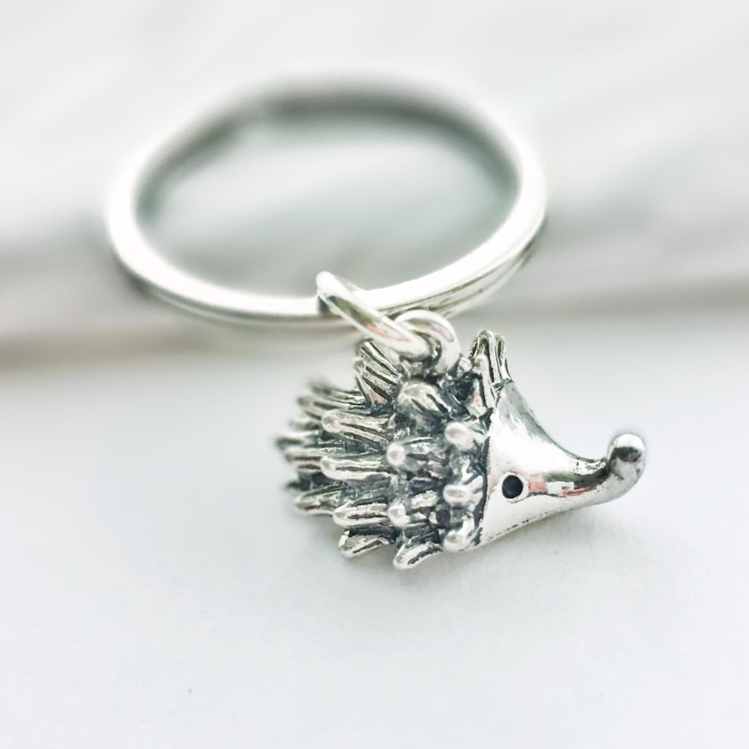 Silver hedgehog keychain on a white background