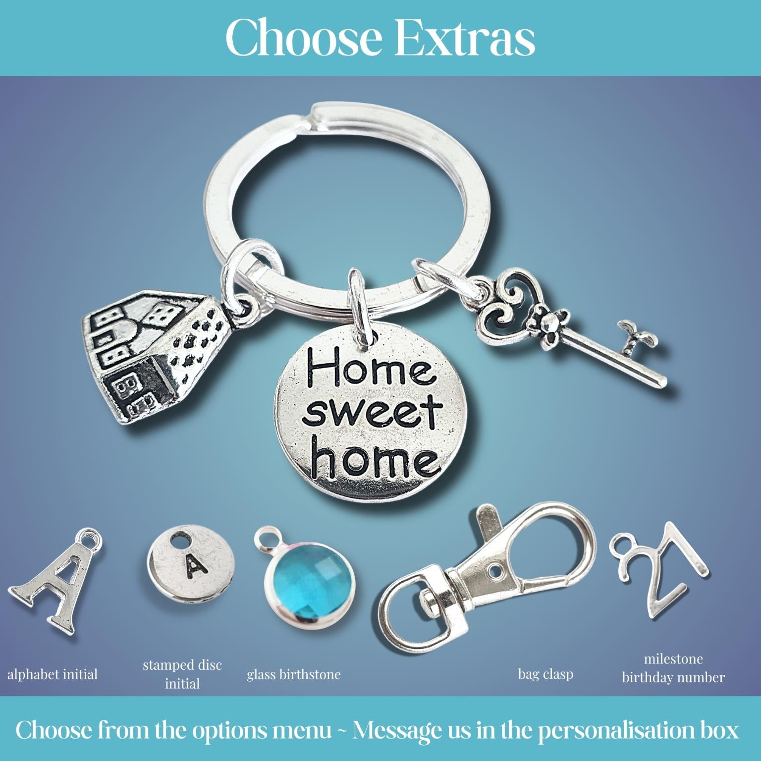 Silver keychain with 'Home sweet home' charm and additional charms on a blue gradient background.