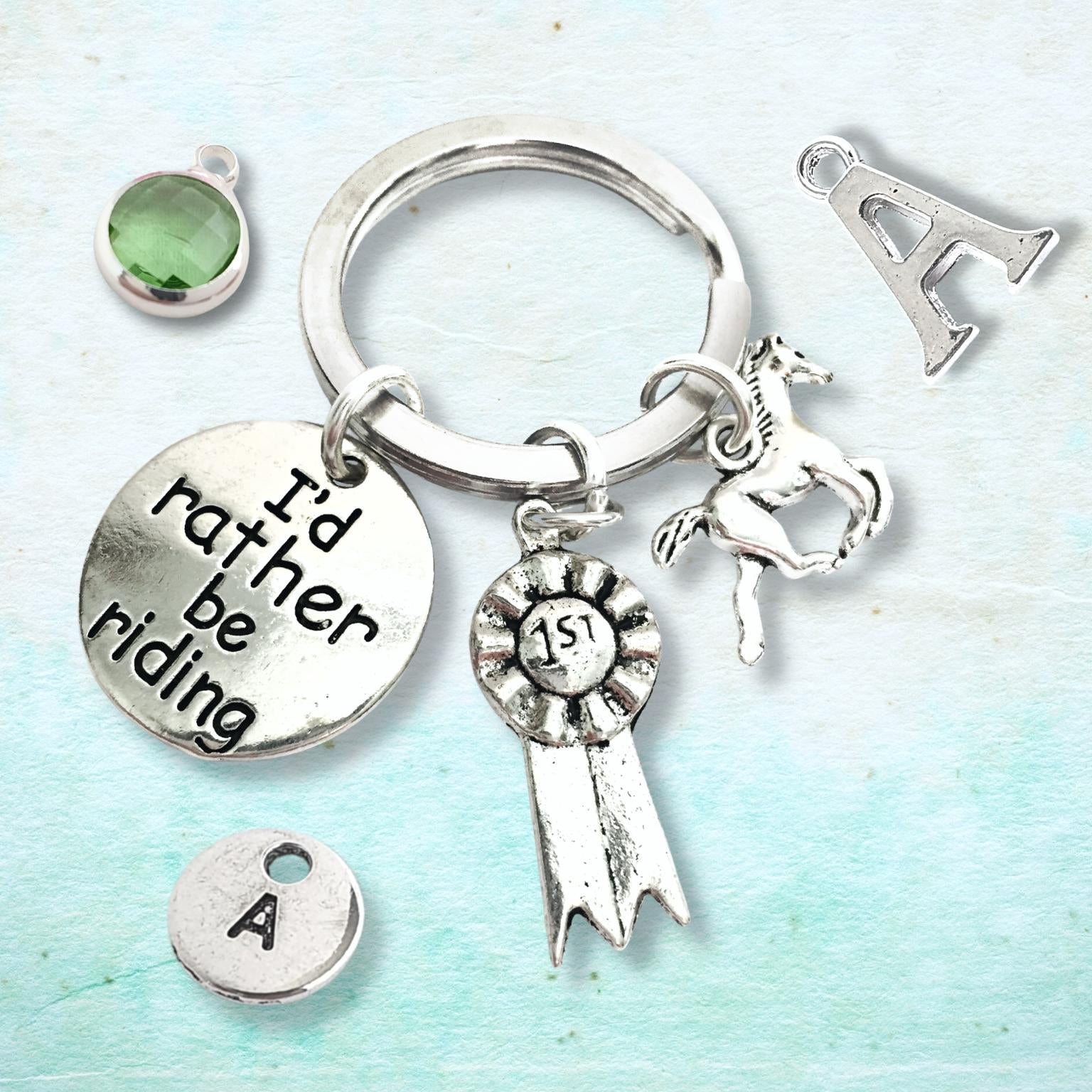 Silver keychain with various charms on a light blue background