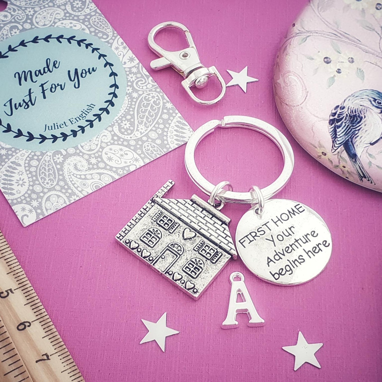 Keychain with engraved text on a pink background with decorative elements