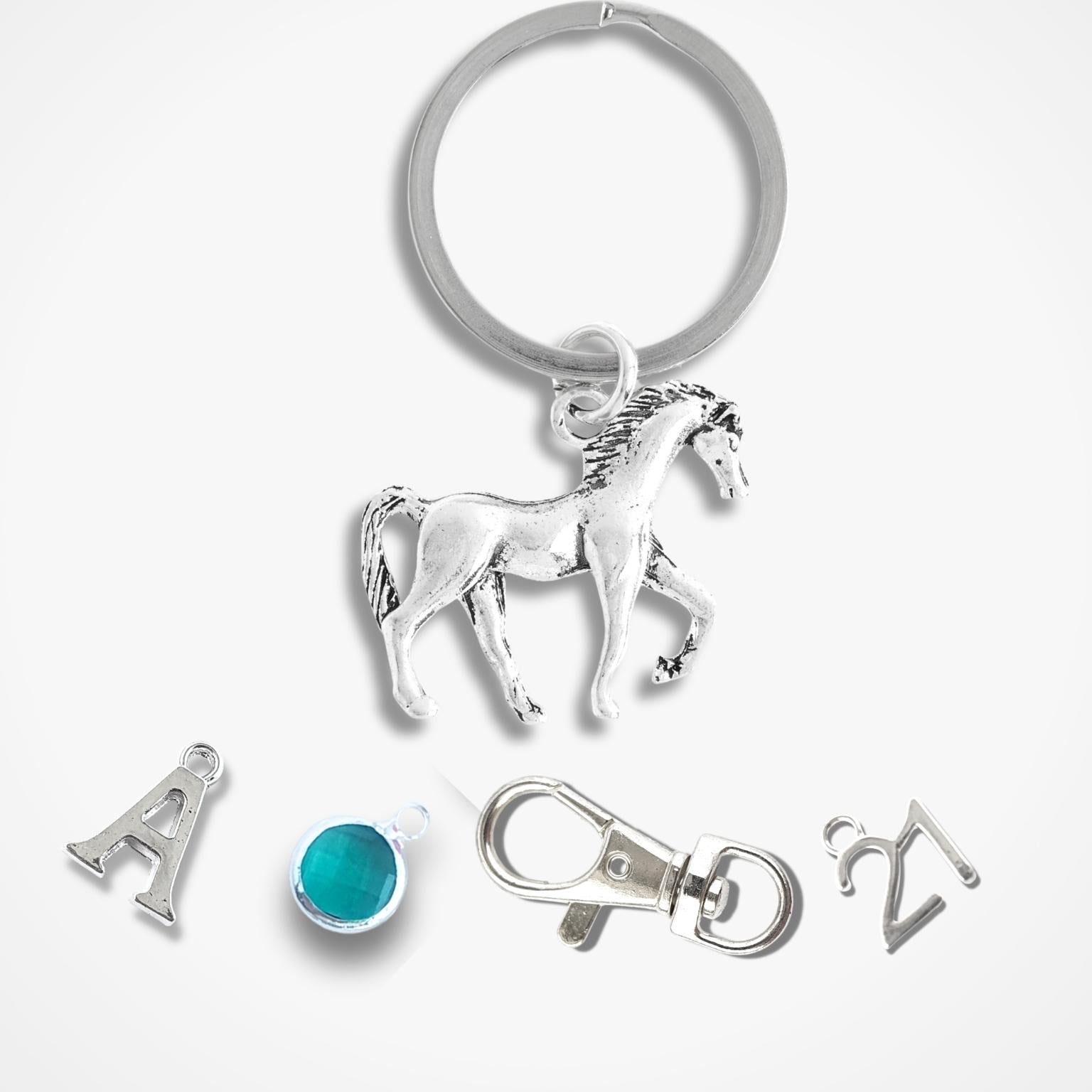 Silver keychain with horse charm and additional charms on a white background