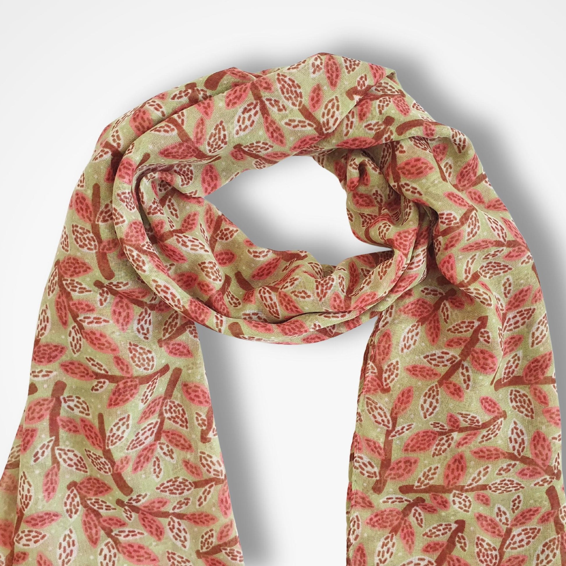 Scarf with dusty rose and brown leaf and branch pattern on a green background