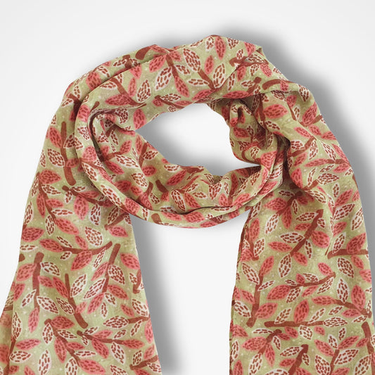 Scarf with dusty rose and brown leaf and branch pattern on a green background