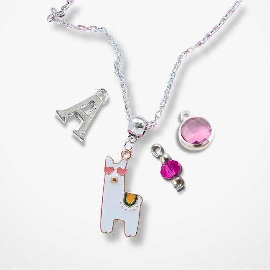 Necklace with various charms including a llama, letter 'A', and pink gem on a white background
