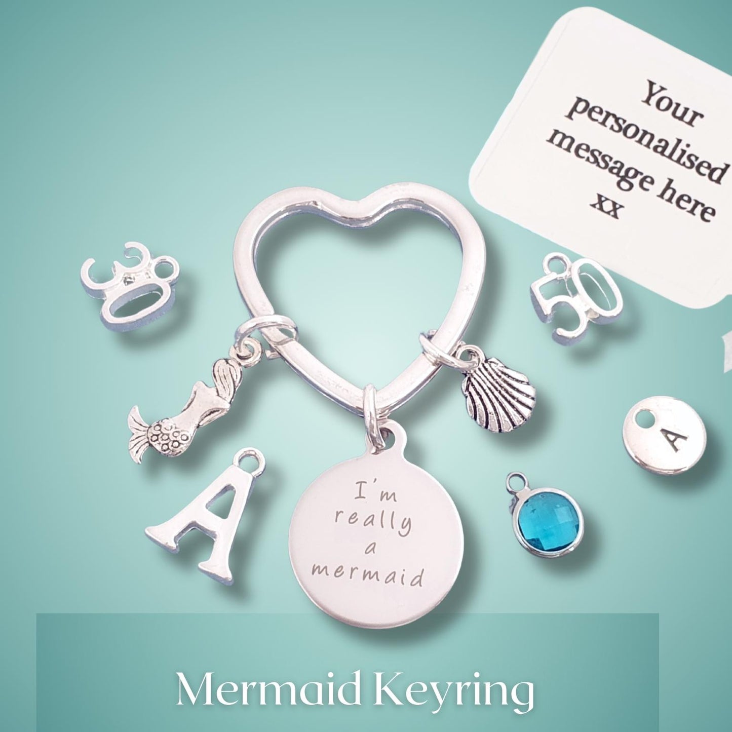 Mermaid keyring with charms on a light blue background