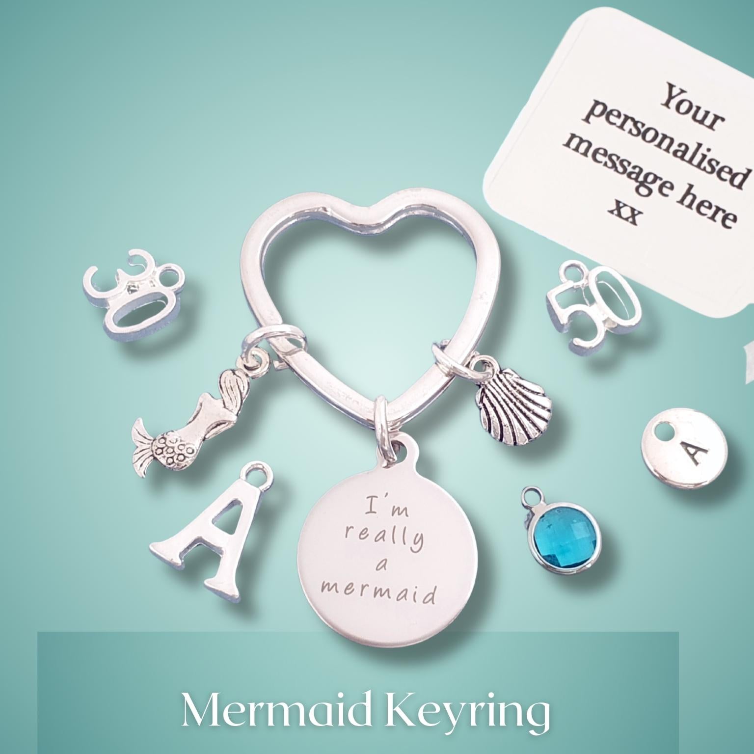 Mermaid keyring with charms on a light blue background