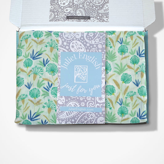 Packaged scarf with floral patterns and 'Juliet English' branding on a white background