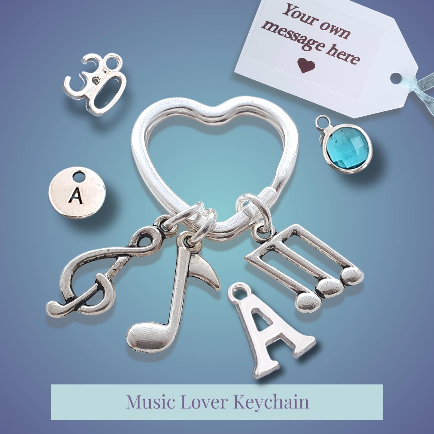 Silver music lover keychain with music note, heart, and letter 'A' charms, shown with customizable charm options and a gift tag on a blue gradient background.