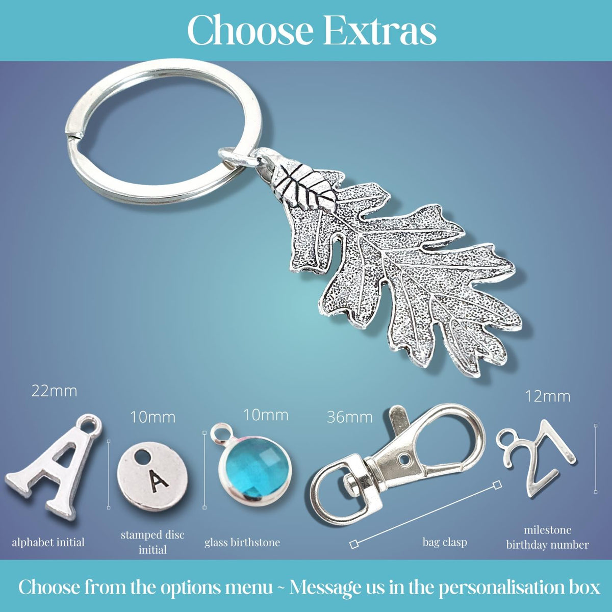 Silver oak leaf keychain with a split ring, shown on a blue gradient background with customization options and dimensions for extra personalization elements.