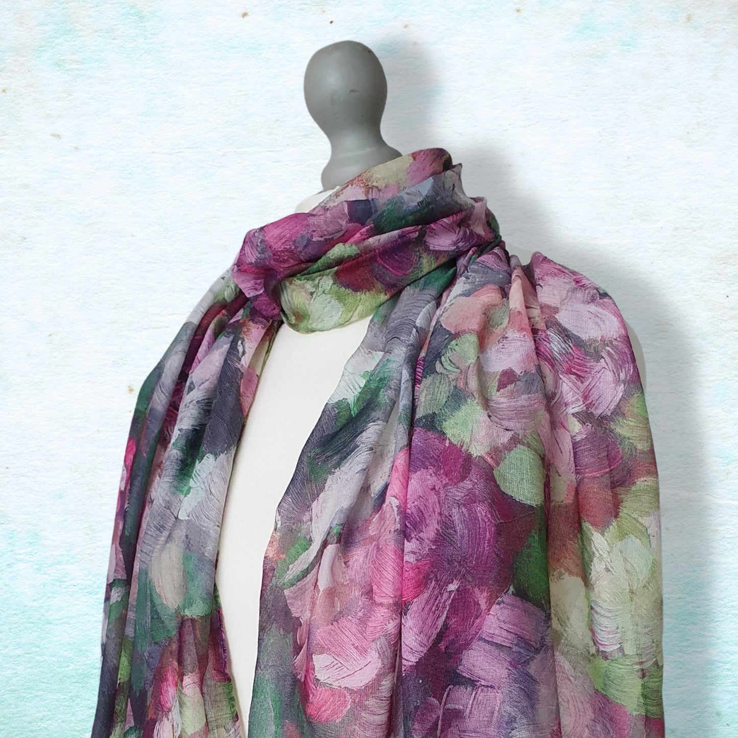 Mannequin wearing a floral scarf against a light background
