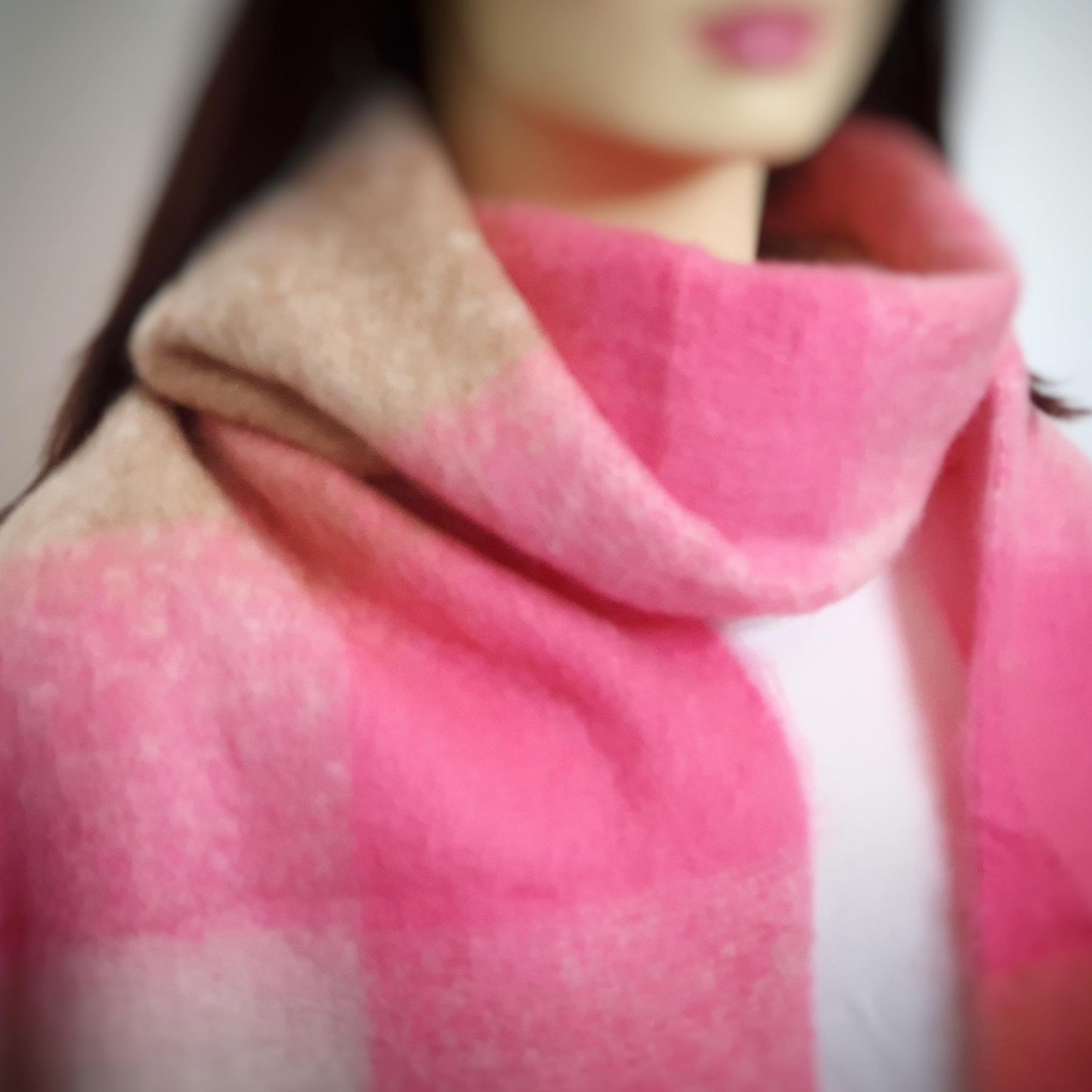 Close-up of a pink blanket scarf with a blurred background