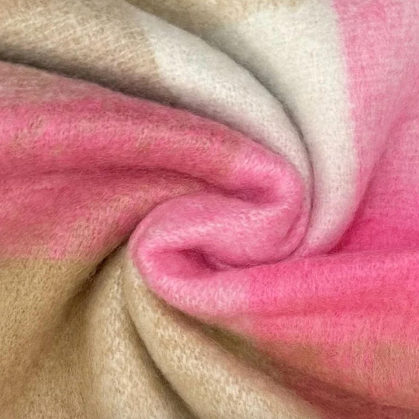 Close-up of pink and beige fabric with a soft texture.