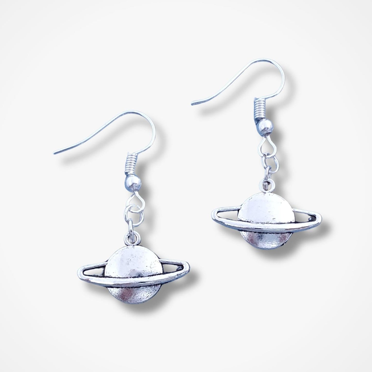 Planet-themed earrings on a white background
