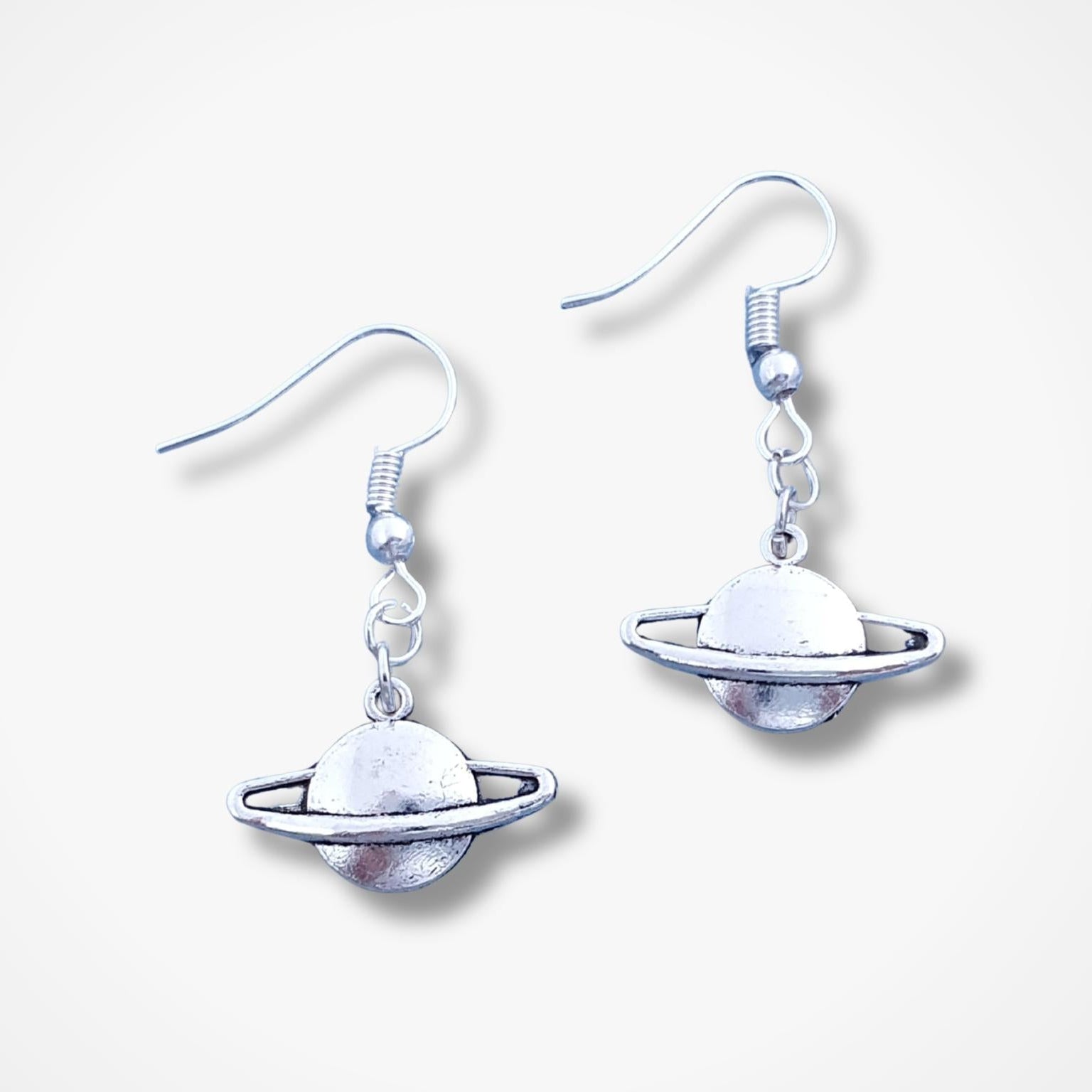 Planet-themed earrings on a white background