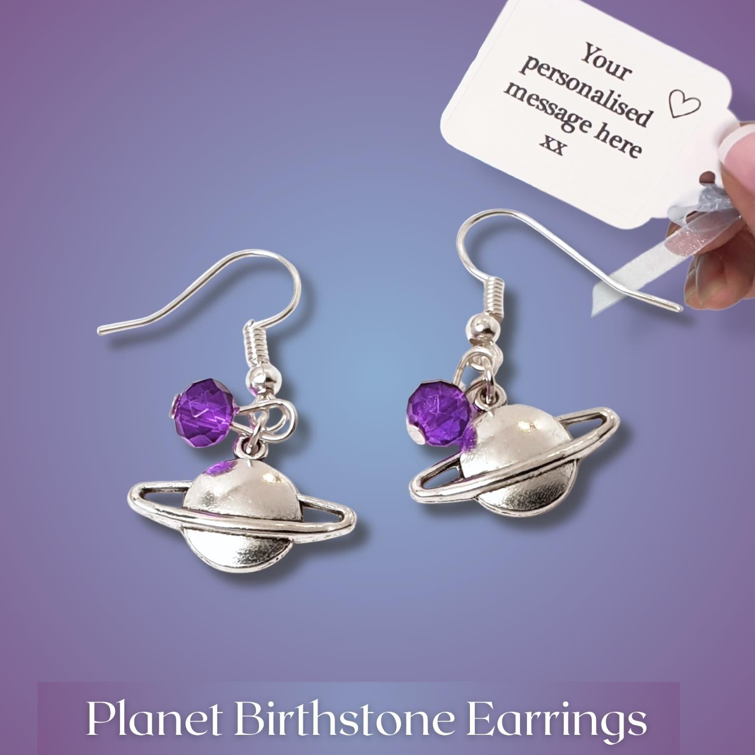 Planet Birthstone Earrings with a hand holding a personalized message card on a purple background