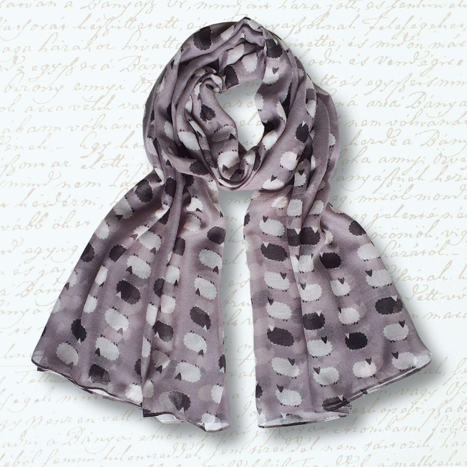Sheep patterned scarf on a textured white background