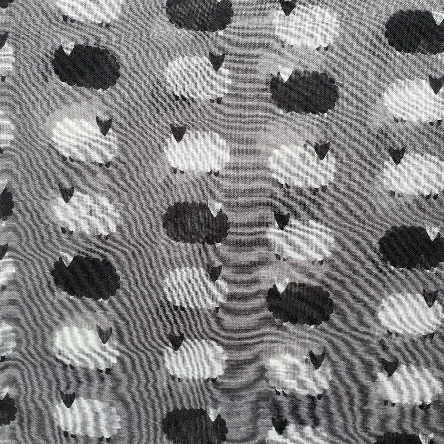 Pattern of black and white sheep on a gray background