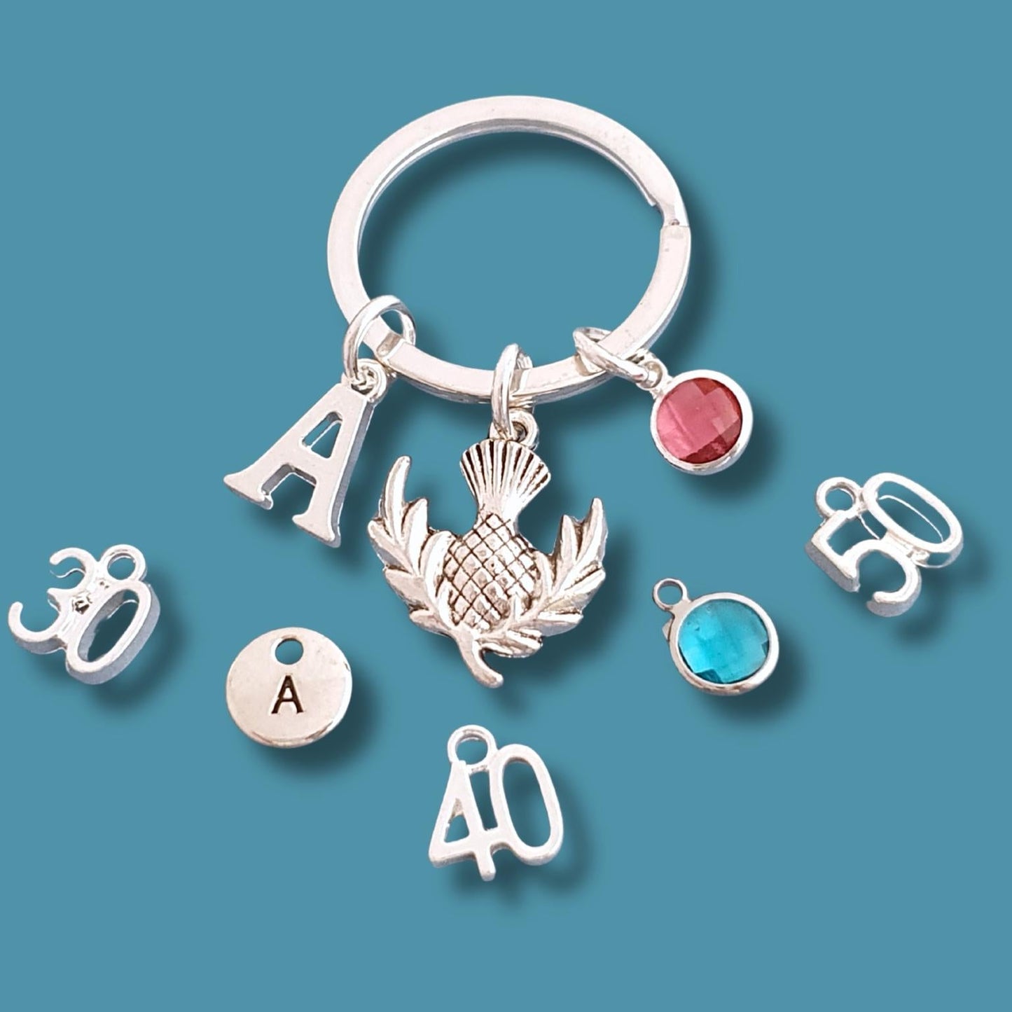 Silver keychain with various charms on a blue background