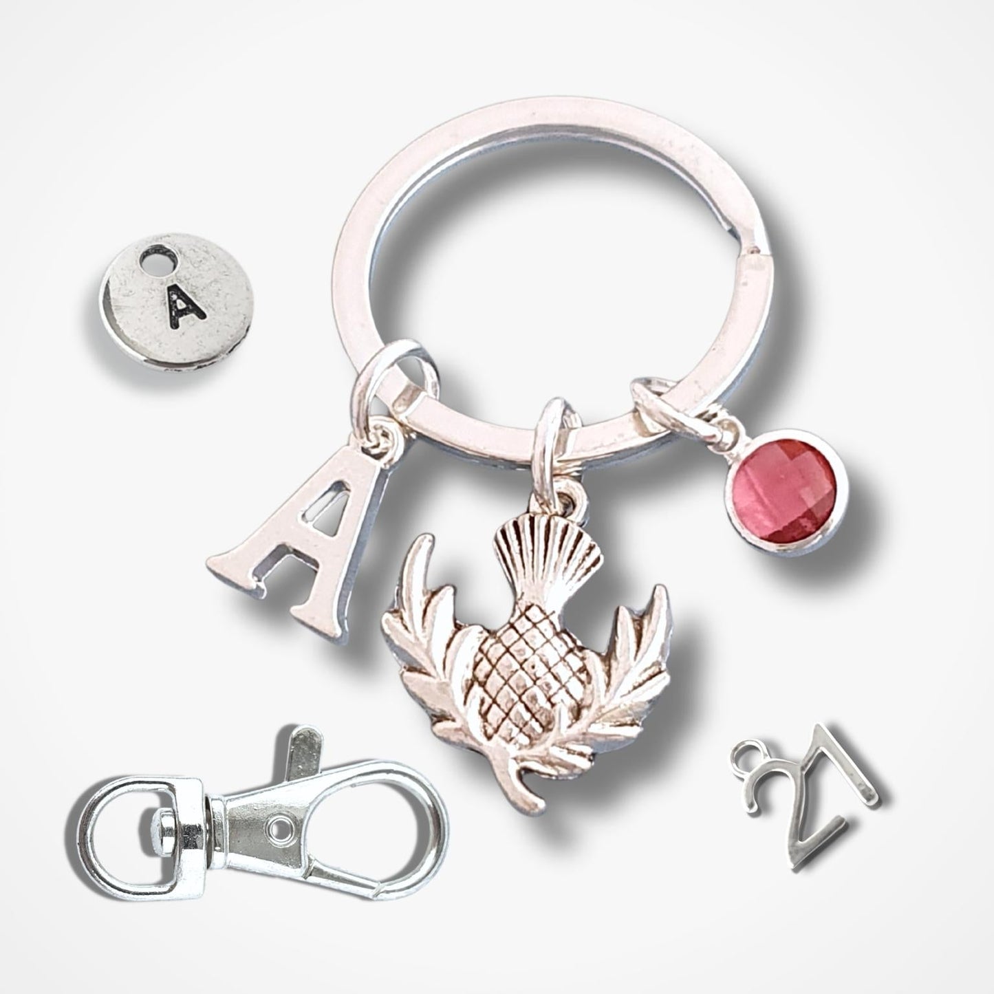 Silver keychain with various charms on a white background