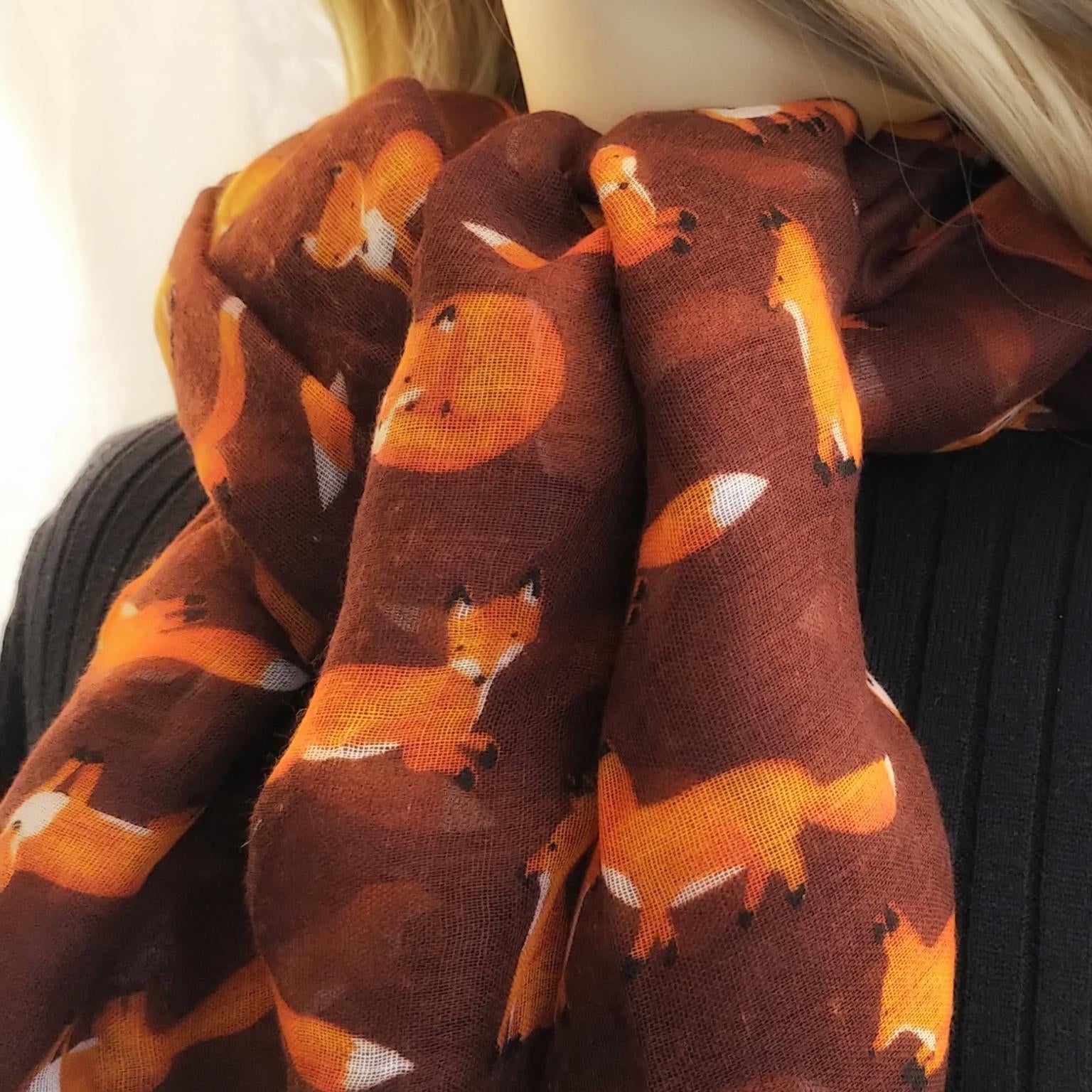 Brown scarf with fox pattern worn by a person