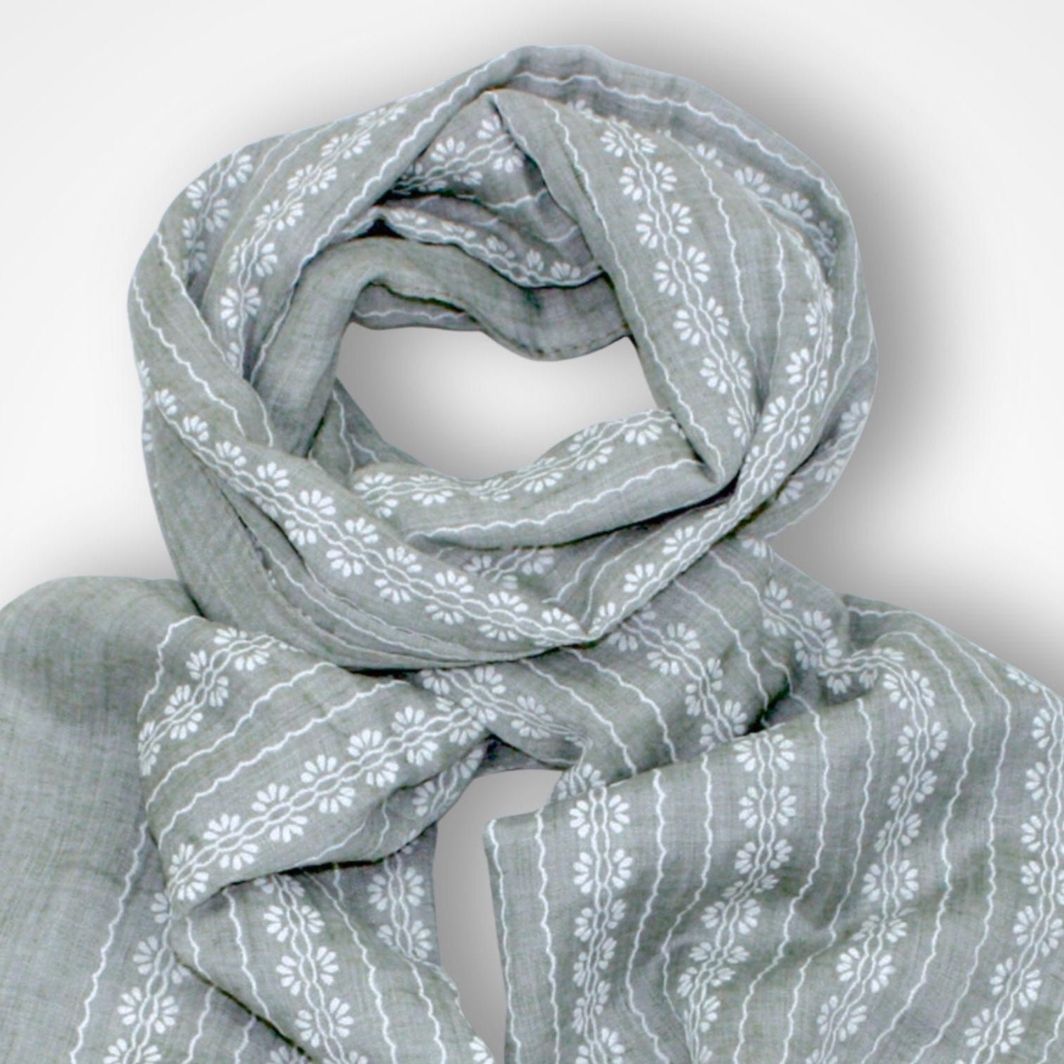 Gray scarf with white floral pattern on a light gray background