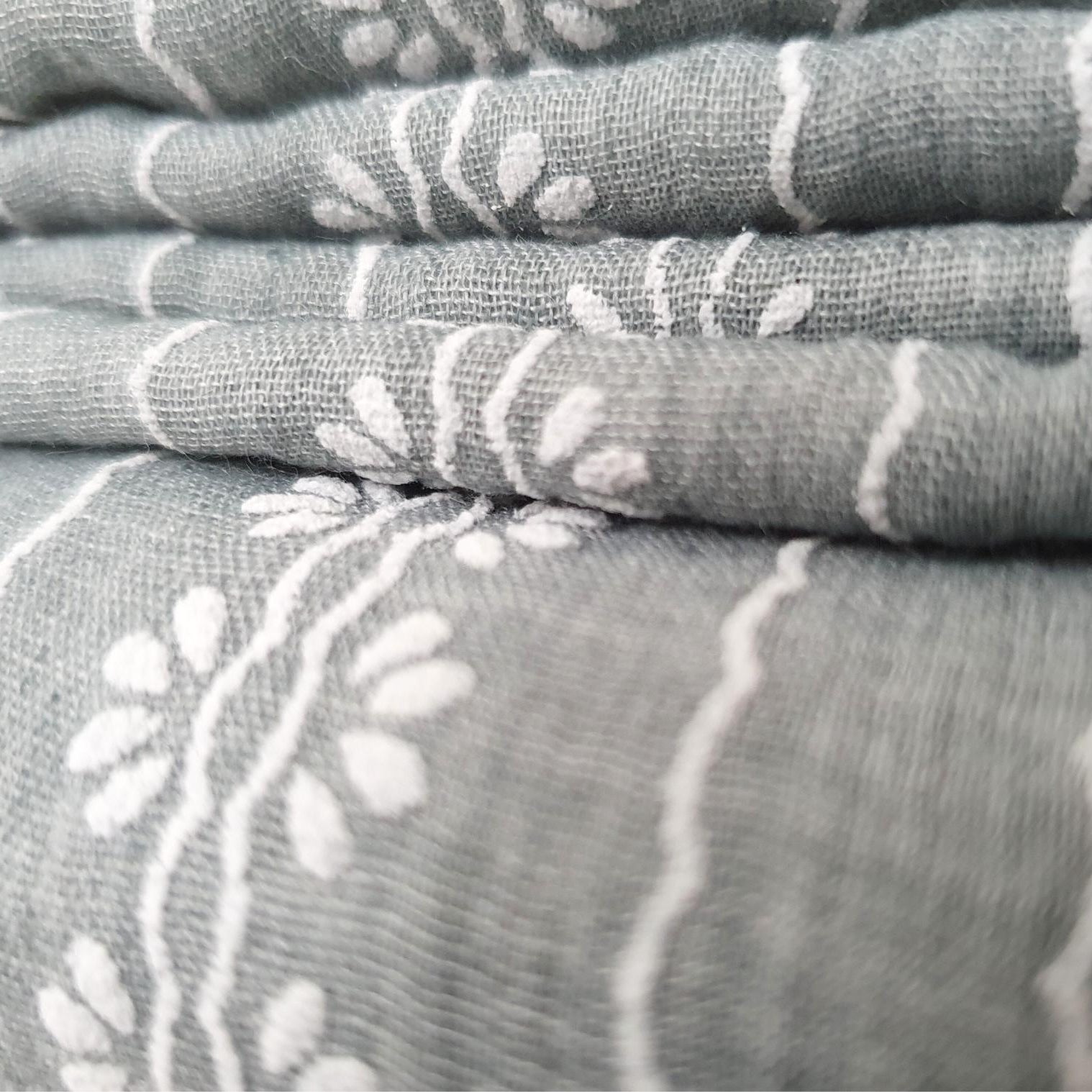 Folded scarf in grey fabric with white patterns