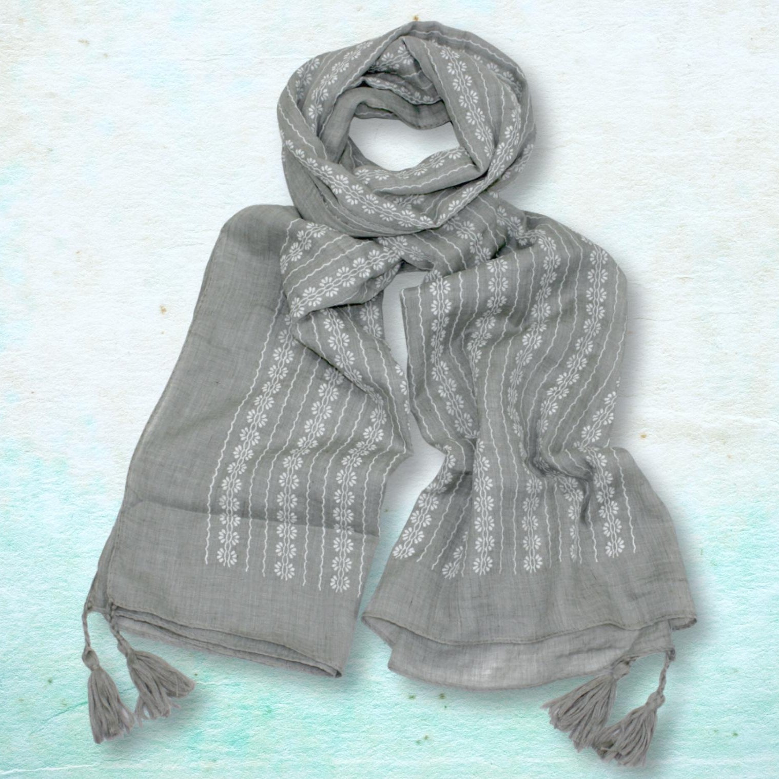 Gray scarf with white patterns on a light blue background