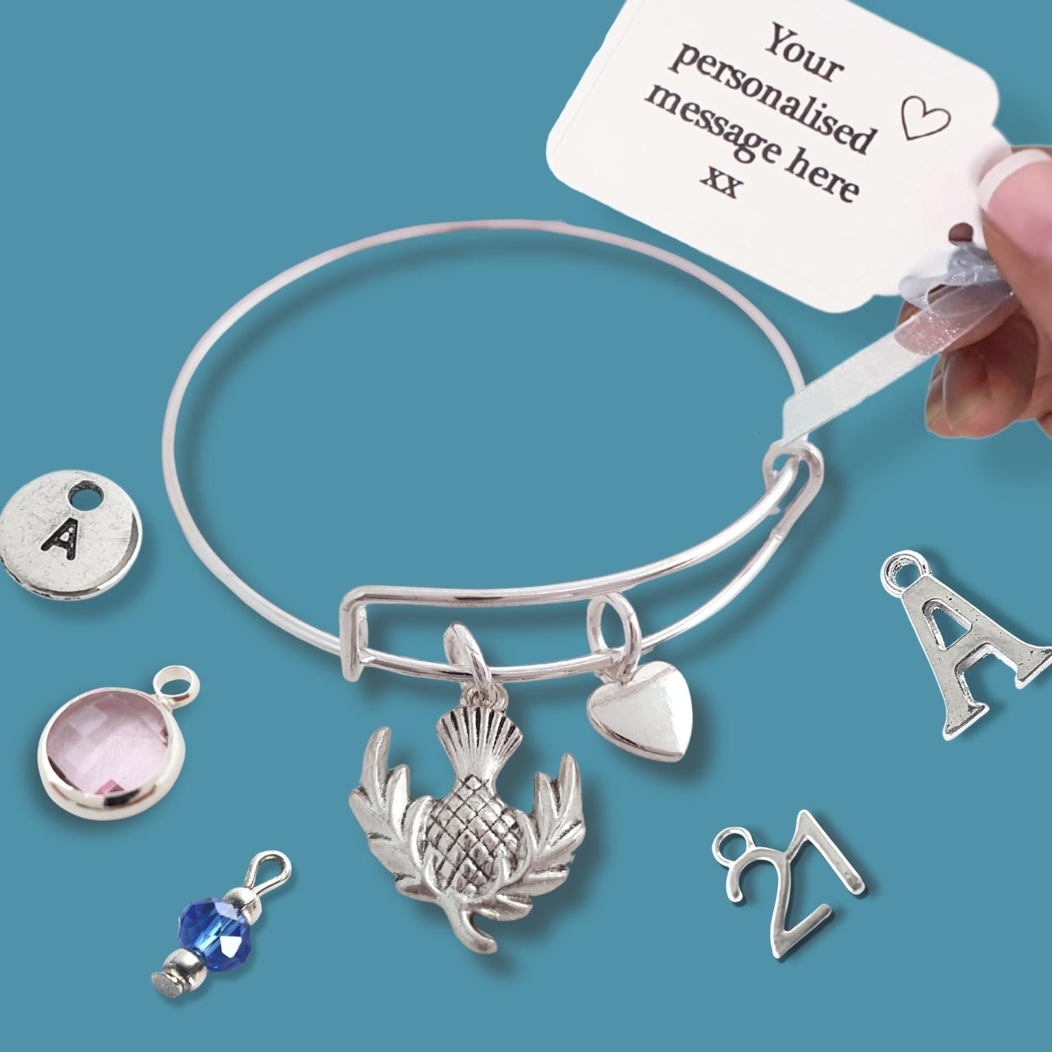 Silver bracelet with various charms on a blue background