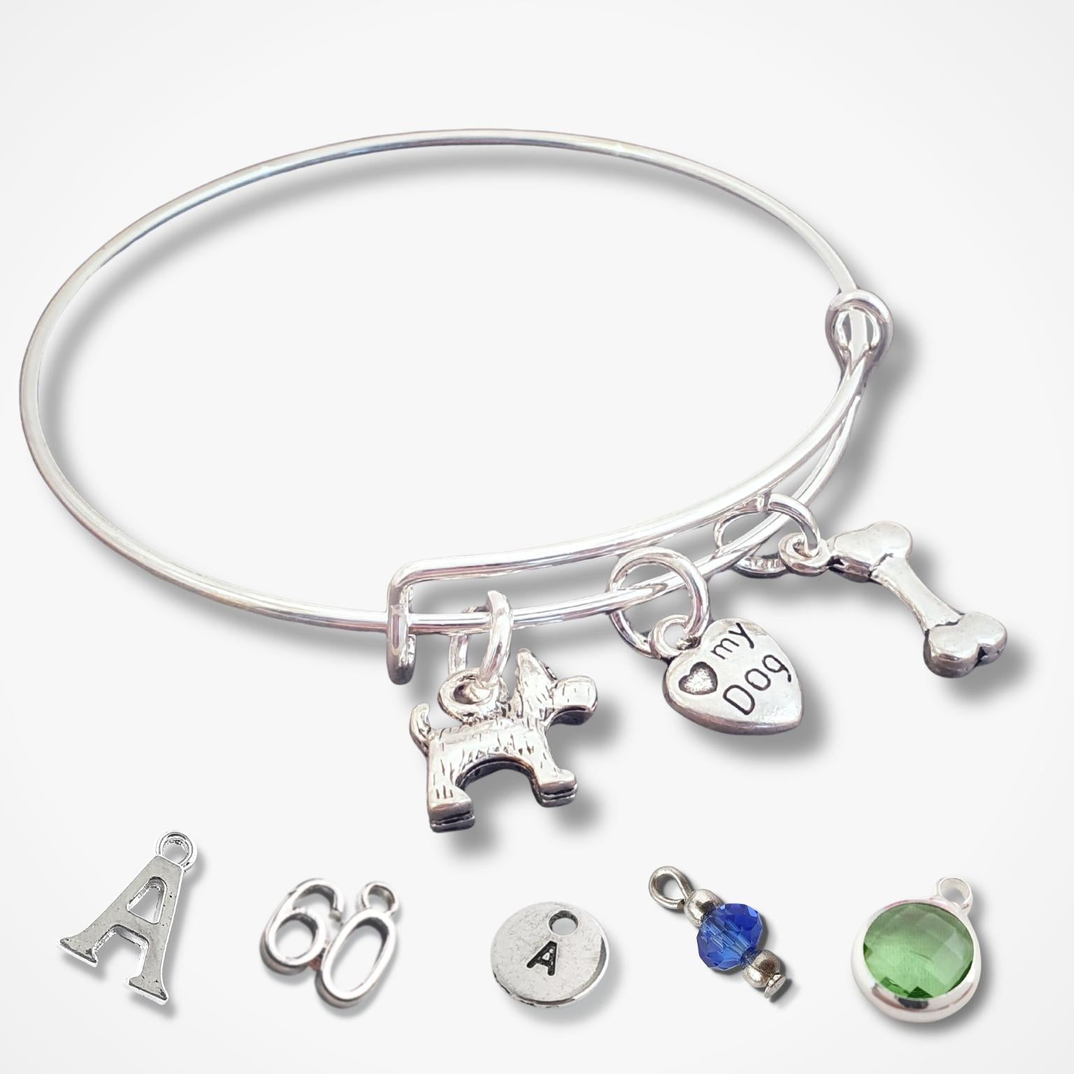 Silver bracelet with various scotty dog theme charms on a white background