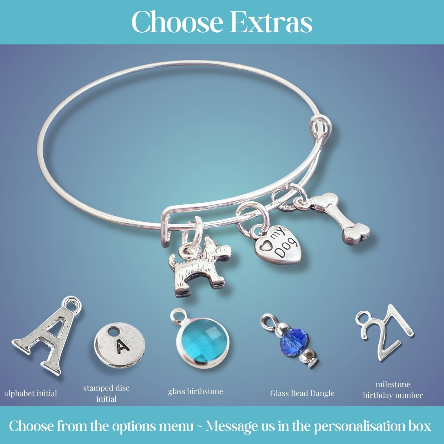 Silver bracelet with various scotty dog theme charms  on a blue gradient background