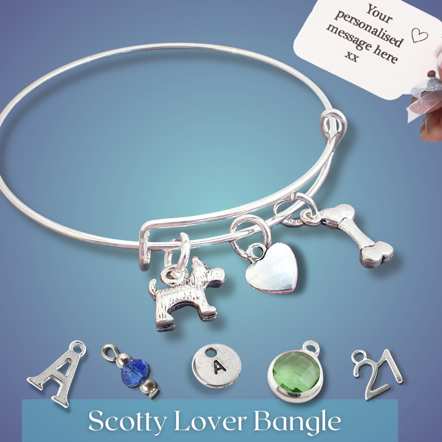 Silver Scotty Lover Bangle with charms on a blue background