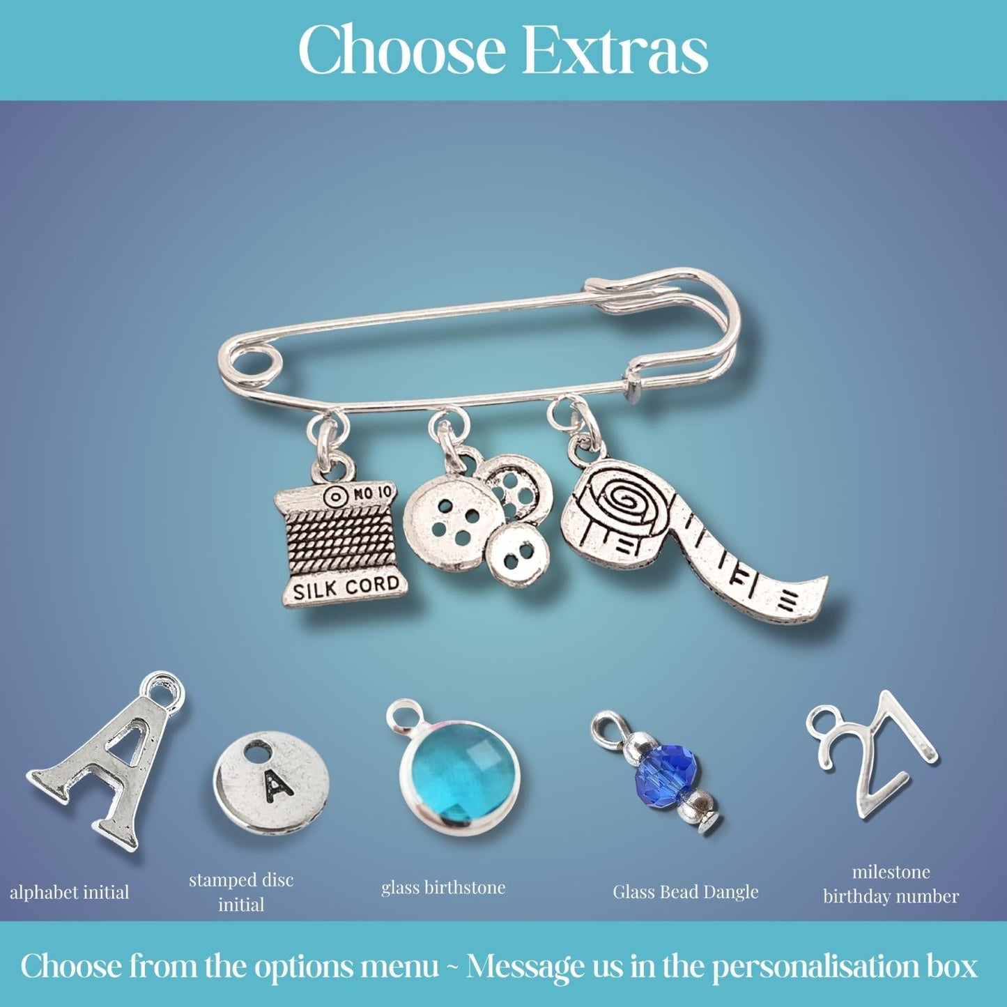 Silver charm brooch with various sewing theme charms on a blue gradient background