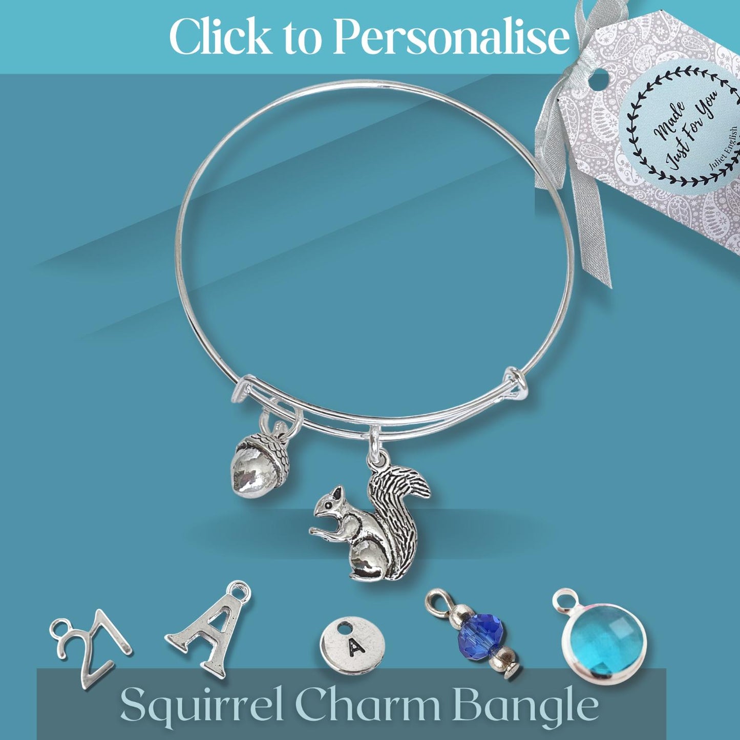 Silver squirrel charm bangle with additional charms on a blue background
