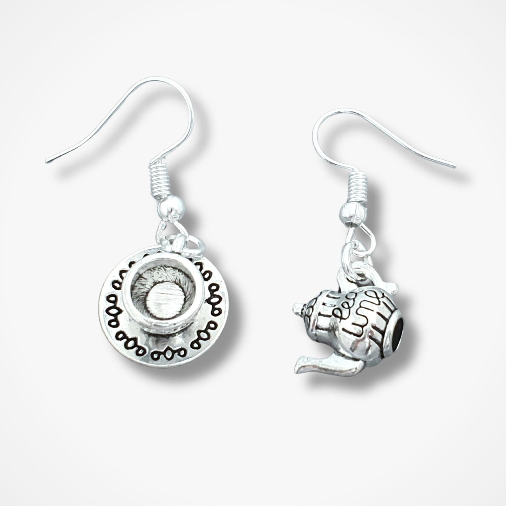 Pair of silver teapot and teacup earrings on a white background