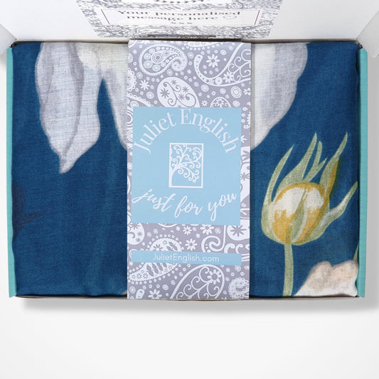 Packaged scarf with floral design and text on a white background