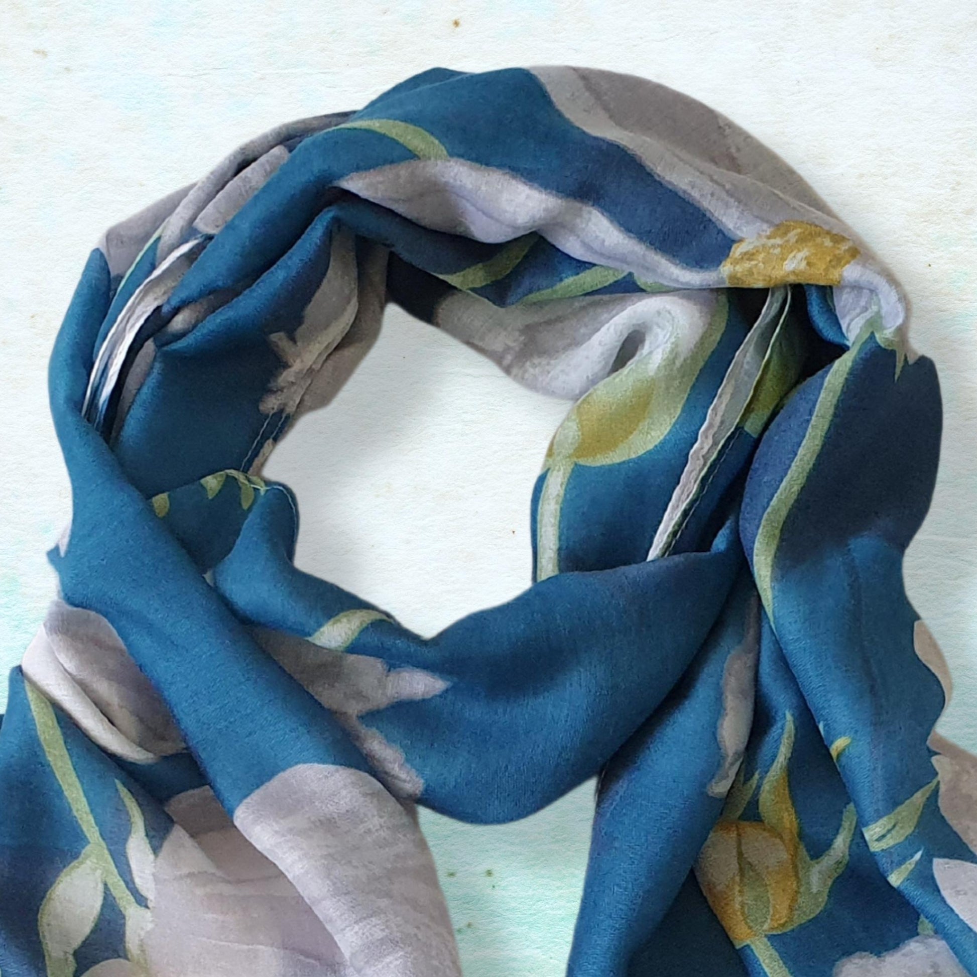 Colorful floral scarf on a light blue background