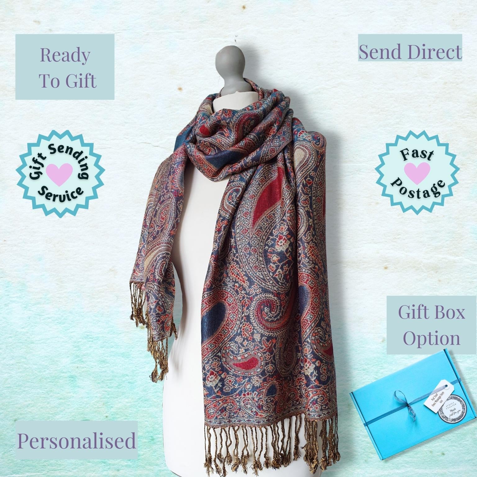 A multicolor paisley scarf with fringe is displayed on a white mannequin torso against a light blue textured background. The image includes promotional text overlays reading 'Ready To Gift', 'Send Direct', 'Personalised', 'Fast Postage', and 'Gift Box Option', along with circular badges.