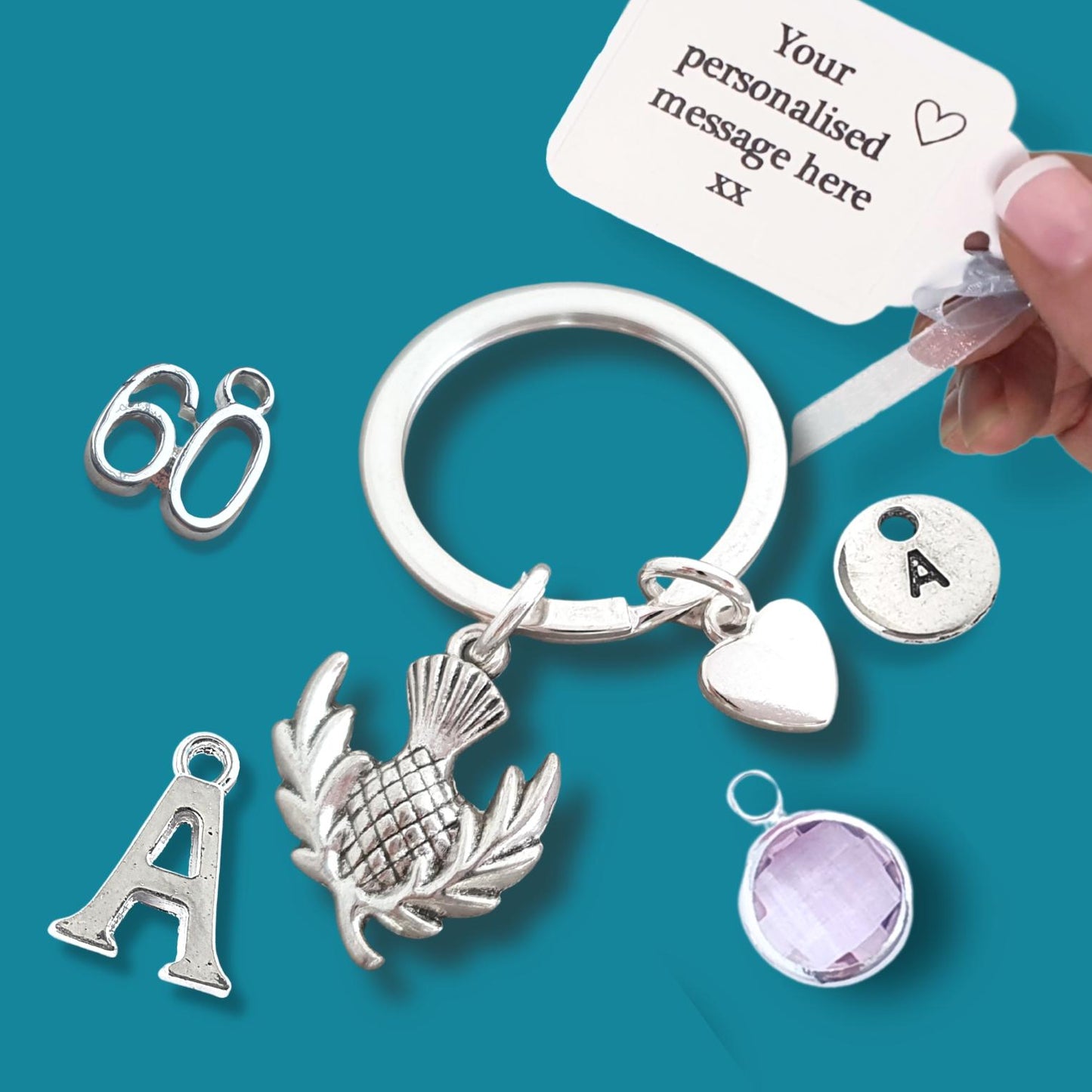 Silver keychain with various charms on a teal background