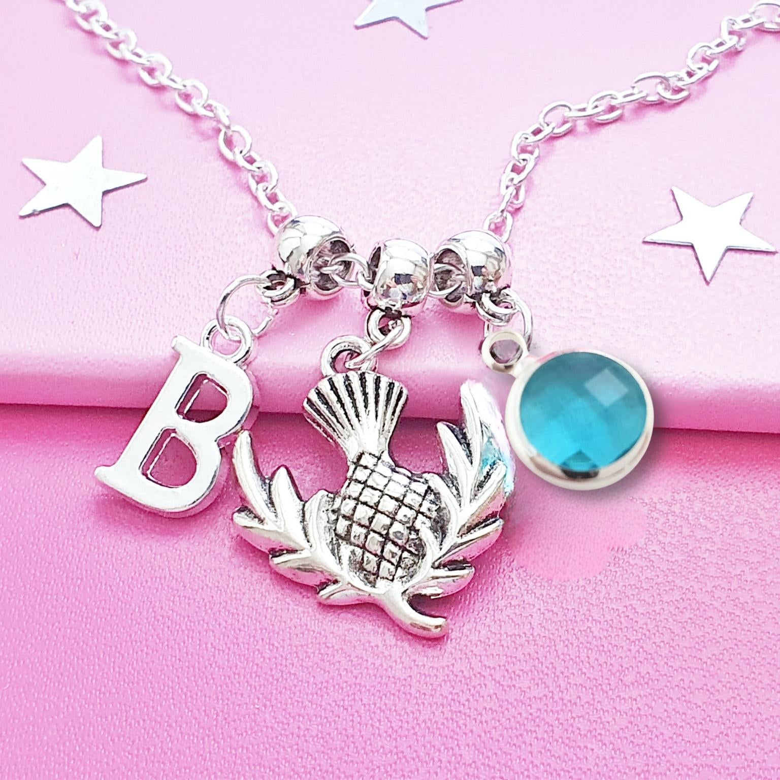 Necklace with charms on a pink background