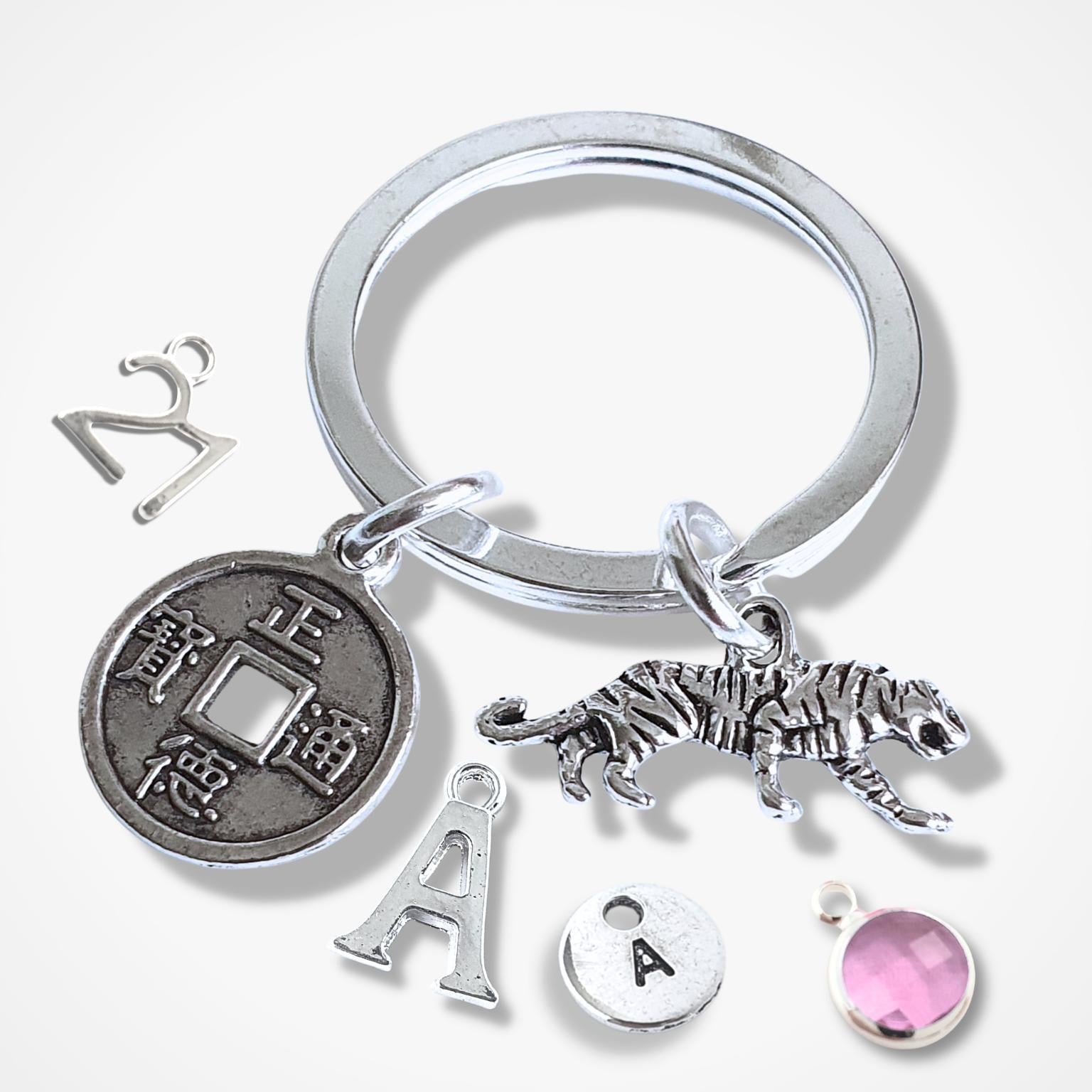 Silver keychain with various charms on a white background