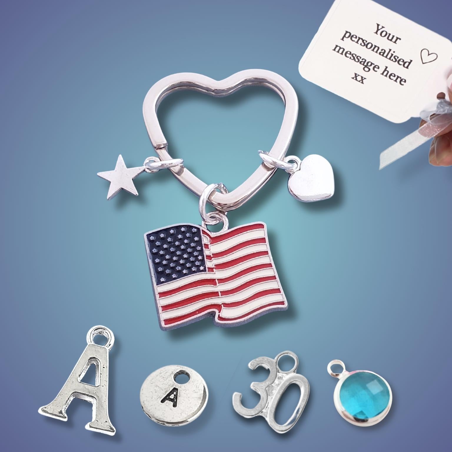 Silver heart-shaped keychain with American flag charm and customizable message card on a blue background