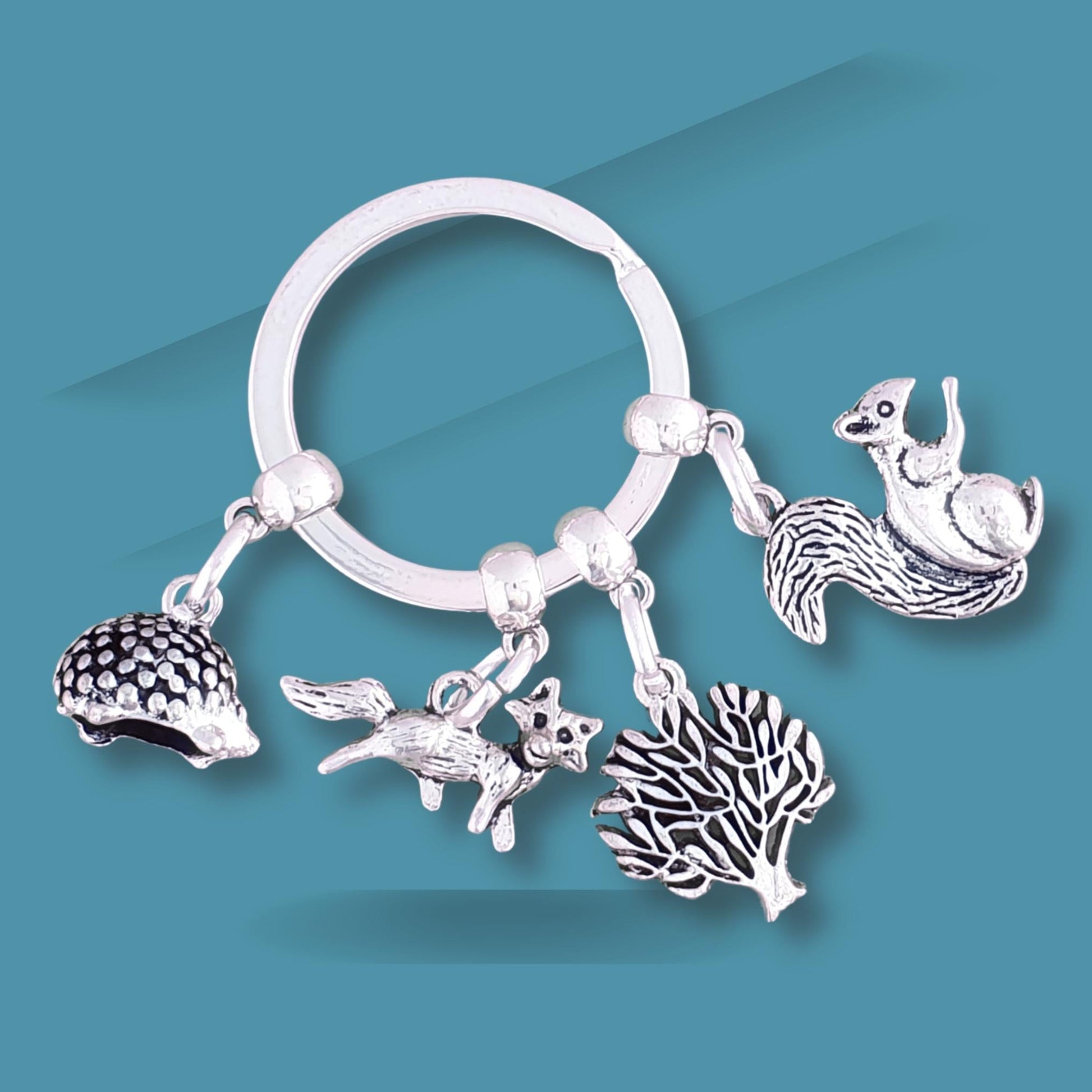 Silver keychain with animal charms on a blue background