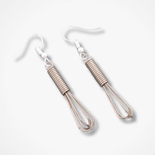 Pair of whisk earrings on a light gray background